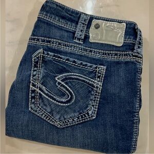 Silver Suki Mid-rise straight dark jeans.